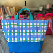 Load image into Gallery viewer, Blue plaid tote bag on a carpeted floor with books in the background