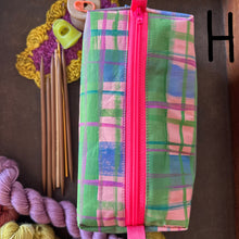 Load image into Gallery viewer, Plaid pouch with pink zipper on a brown surface with yarn and knitting needles.