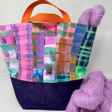 Load image into Gallery viewer, Colorful fabric with a plaid pattern and a ball of purple yarn on a white background
