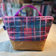 Load image into Gallery viewer, Plaid fabric bag with a brown base on a surface with a blurred background
